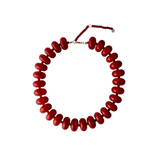 Cleo bright red chunky beaded statement necklace lying flat against a white background